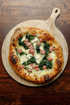 Craft pizza with cheese, meatballs and herbs isolated.
