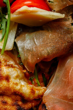 Texture of pizza with basil, mozzarella, tomatoes and ham close-up