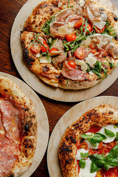 Prepared craft pizzas with various toppings in an authentic pizzeria