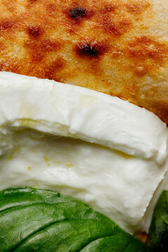 Texture of pizza with basil, mozzarella, tomatoes and ham close-up