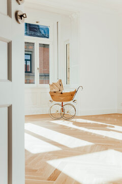 Pram in empty room, open doors