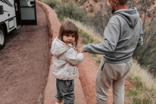 Father and daughter exploring near RV campsite