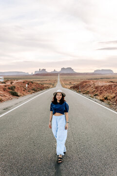Woman walking on iconic road in Monument Valley