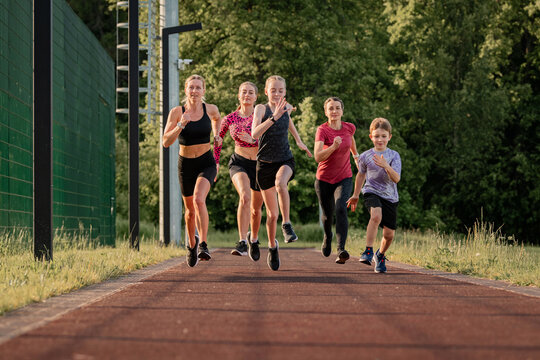 Group of runners training together on an outdoor track