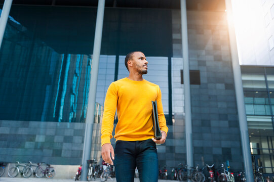 Young man with file wearing yellow pullover