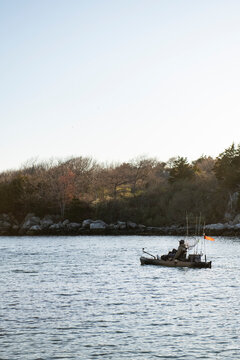 Man in a fully equipped fishing kayak on the water