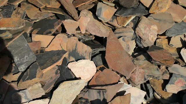 Natural Decorative Stone Cladding Materials Close Up. Close-up footage of natural decorative stone pieces in various colors and shapes displayed at a building materials store.