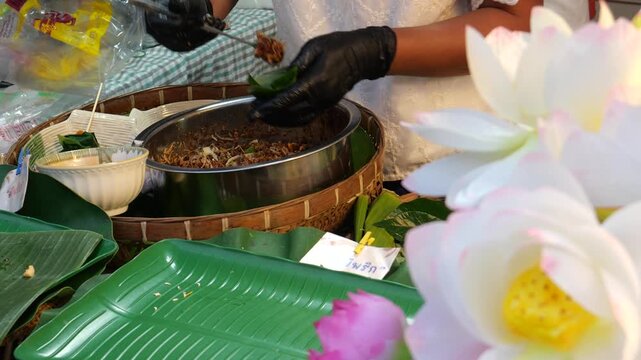 Making Miang Kham (traditional Southeast Asian herbal snack from Thailand and Laos), Traditional Thai snack. It&rsquo;s a snack containing different ingredients of herbs and vegetables. It helps balance the