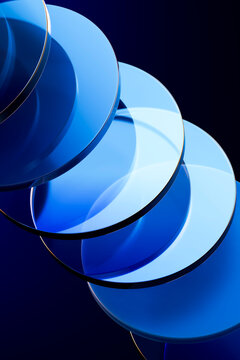 Abstract 3d blue glass circles overlapping on a dark background