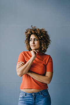 Portrait of a pensive woman with hand on chin