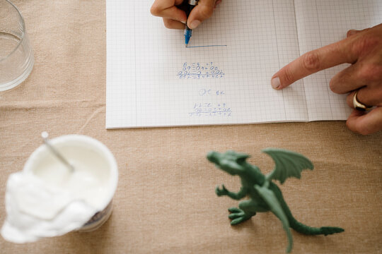 Father helping son with math schoolwork at home