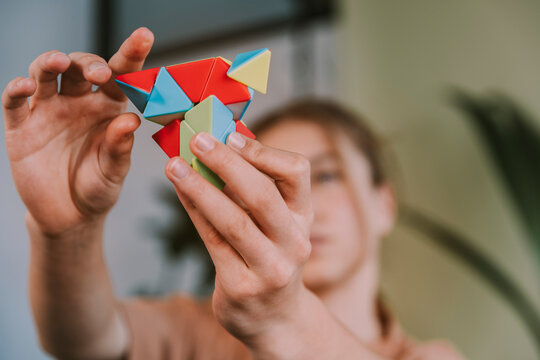 Girl solving puzzle toy at home