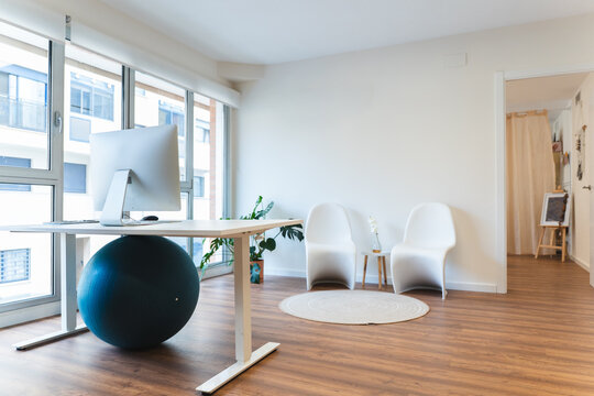 Modern office with standing desk and ergonomic fitness ball