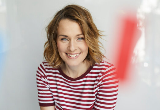 Portrait of smiling woman wearing red-white striped t-shirt