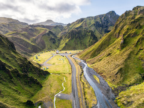 Aerial view of Pakgil campsite in a green mountain valley in Iceland