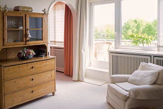 Living room with armchair and old cupboard