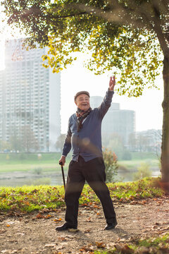 Happy senior man walking by the riverside