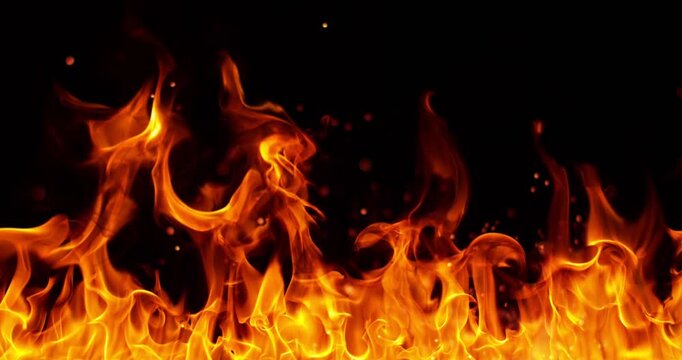 Ultra slow motion fire flames with glowing embers and sparks on black background captured at 1000 FPS. Dramatic combustion effect ideal for cinematic overlays and visual effects.