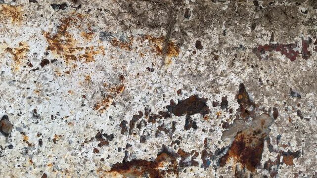 Close up abstract of rust and textured surface moving shot with paint flaking UK 4K