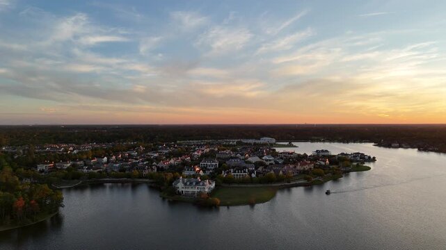 Aerial view of luxury houses in Houston, Woodlands by the lake with dramatic sky by sunset in Texas, United States