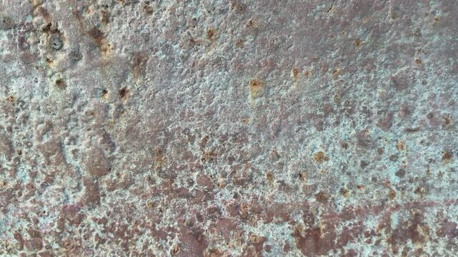 Close up abstract of rust and textured surface moving shot with paint flaking UK 4K