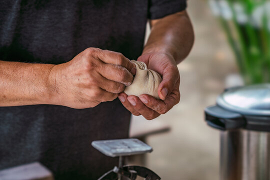 The art of dumpling making. An artisan chef demonstrates the culinary craft of pleating dough by hand for a gourmet meal.