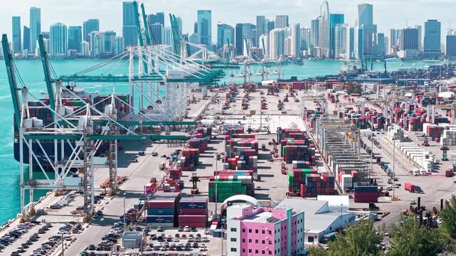 Miami, Florida, USA - April 02, 2025: Freight container of cargo. Port Miami. Container loading. Export and import. Cargo business. 4k footage. Cargo services with container in port, aerial view