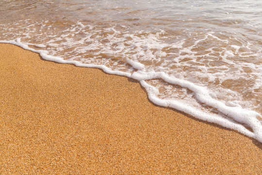 Sunny beach in Hawaii with golden sand, clear water under a bright sky