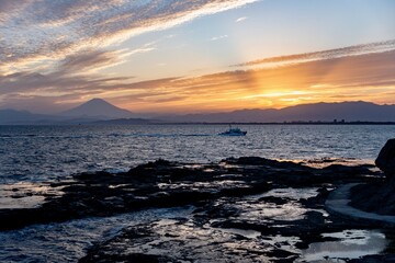 Fototapeta premium Mount Fuji at Sunset with Fishing Boat Viewed from Chigogafuchi, Enoshima Island, Japan