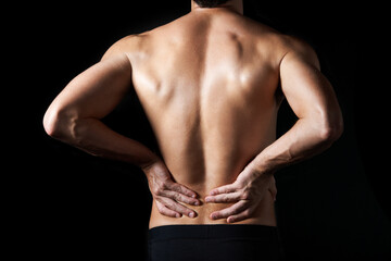 Fototapeta premium Shirtless, body and man in studio for back pain, inflammation or injury with arthritis. Fibromyalgia, sprain and male person by black background with muscle tension, accident or joint ache.