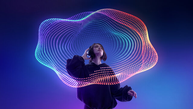 Young woman listening to headphones under colorful digital sound wave mesh. Concept of music streaming app, immersive audio platform, playlist promotion and digital media campaign.