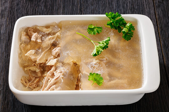 Cold meat aspic dish on dark wood table