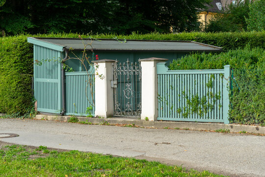 Green Garden Shed with Ornate Gate