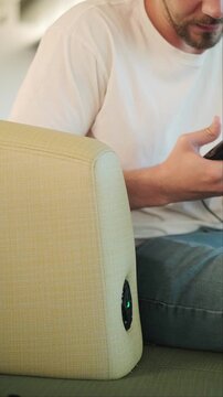 Man at airport waiting area connects smartphone to charging station while waiting for flight moden travel infrastructure passenger convenience and digital mobility for seamless journeys global use