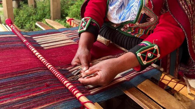 Indigenous andean woman creating colorful handmade fabric using traditional weaving techniques in Peru