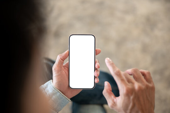 Close up of a person tapping white screen smartphone display, illustrating mobile app interaction.