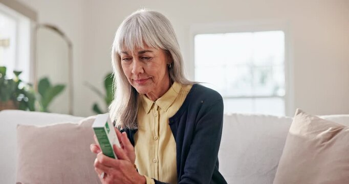 Reading, medicine and old woman in home with box, supplement benefits and side effects. Elderly person, check drugs and pharmaceutical product for healthcare information, multivitamin and pills