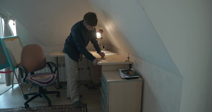 Kid Boy Wipe Desk with Wet Sponge Cleaning Table in Room. 4K 10-bit