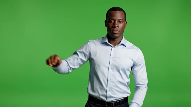 Man gesturing with hands during presentation against a green screen background