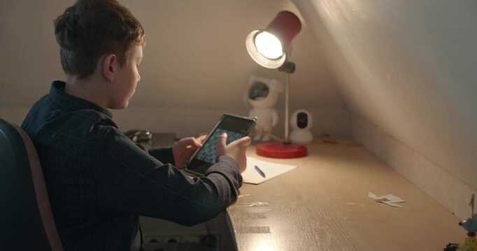Kid Boy Play Chess on Tablet. 4K 10-bit