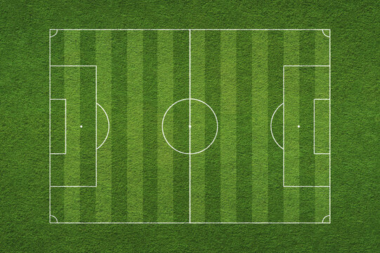 Empty striped soccer, football field texture. Green grass texture - well-groomed turf in the garden or soccer stadium