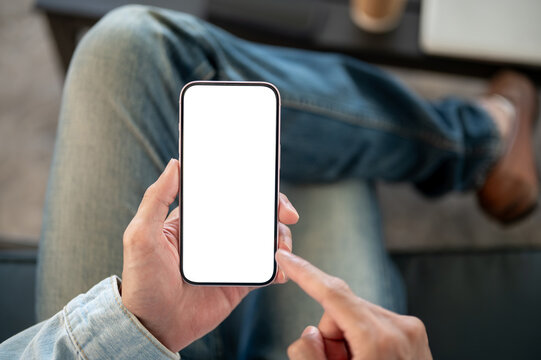 Close up of hand holding and pointing at blank smartphone screen perfect for mobile app presentation
