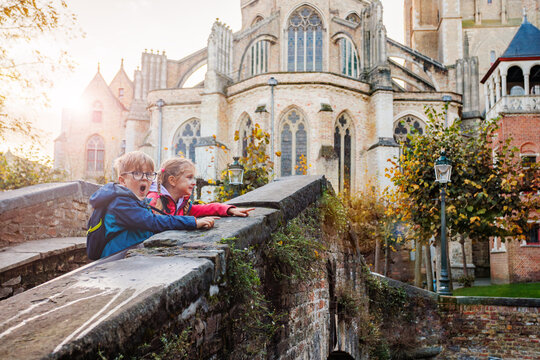 Two children sightseeing on Boniface bridge Bruges, Belgium