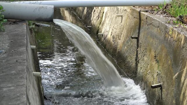 Industrial Wastewater Discharge Flowing from Drain Pipe into Sewer Channel for Water Treatment and Environmental Management