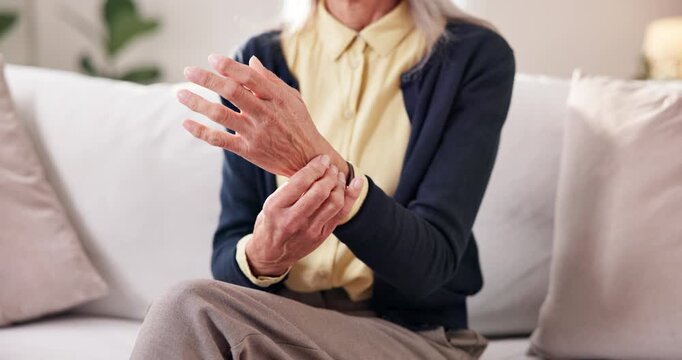 Home, hands and senior woman with wrist pain for arthritis, nerve compression and inflammation. Retirement, elderly person and muscle massage on sofa with discomfort, rheumatism risk and osteoporosis