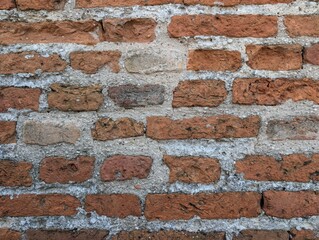 Naklejka premium Horizontal view of an ancient medieval red brick wall texture in Italy. 