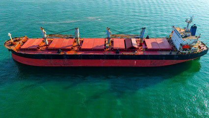 Side profile aerial perspective of a heavy bulk cargo ship anchored offshore © Buğra Kaan Ersoy