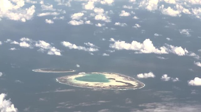 4k aerial landscape video footage of Saint-Joseph-Atoll and D'Arros Island as part of the Amirante Islands group in the territory of Seychelles, located in Indian Ocean - partly covered with clouds