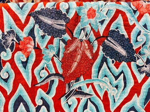 Floral, leaf, and cloud motifs from the city of Cirebon on Indonesian batik fabric, featuring a beautiful dominance of red and blue colors
