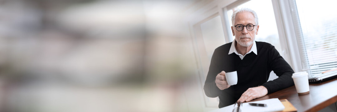 Portrait of businessman having coffee break; panoramic banner